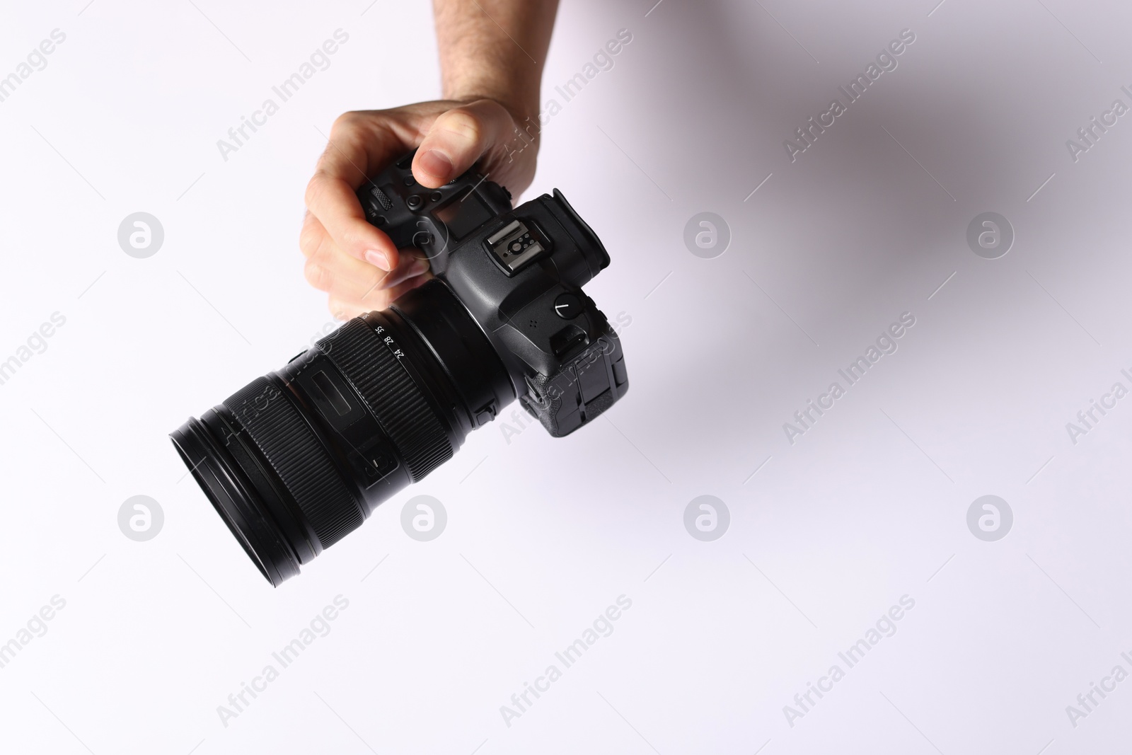 Photo of Photographer with professional camera on light background, above view. Space for text