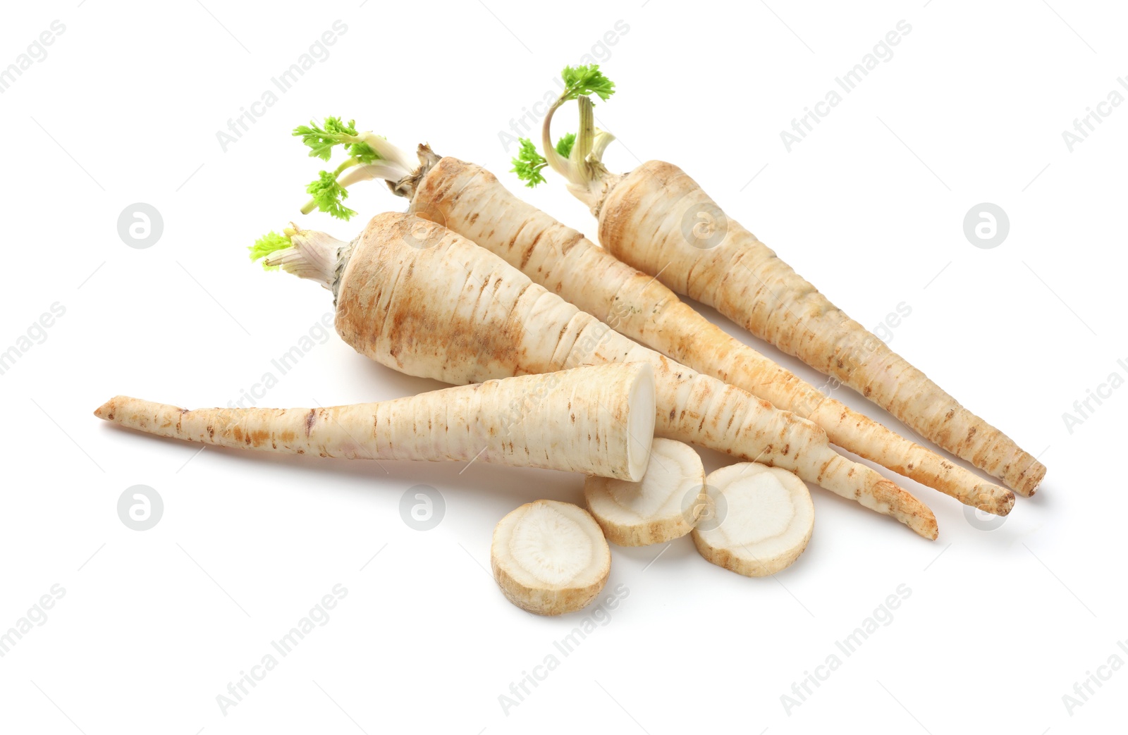 Photo of Whole and cut fresh parsley roots isolated on white