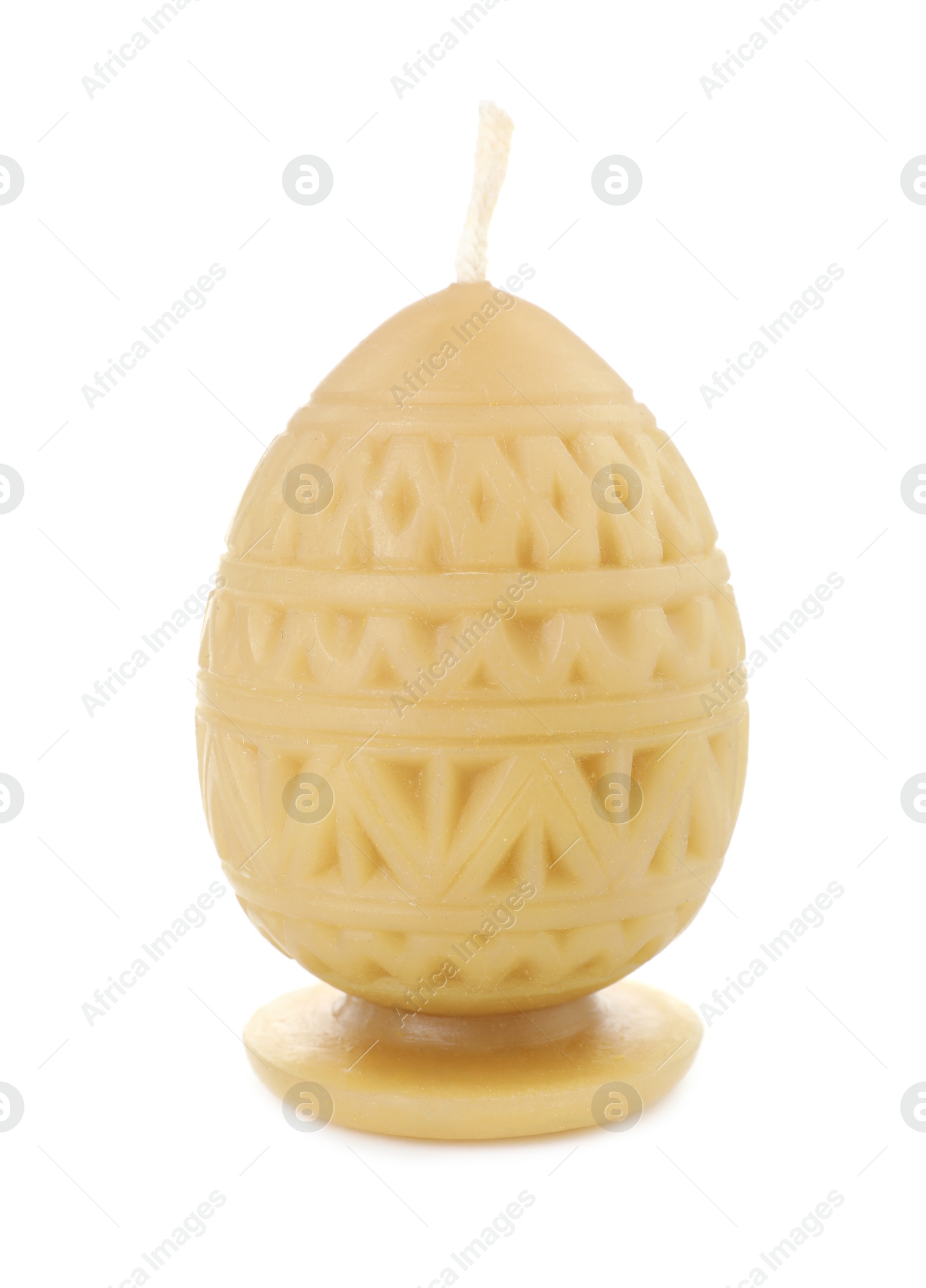 Photo of Yellow egg-shaped candle isolated on white. Easter decor