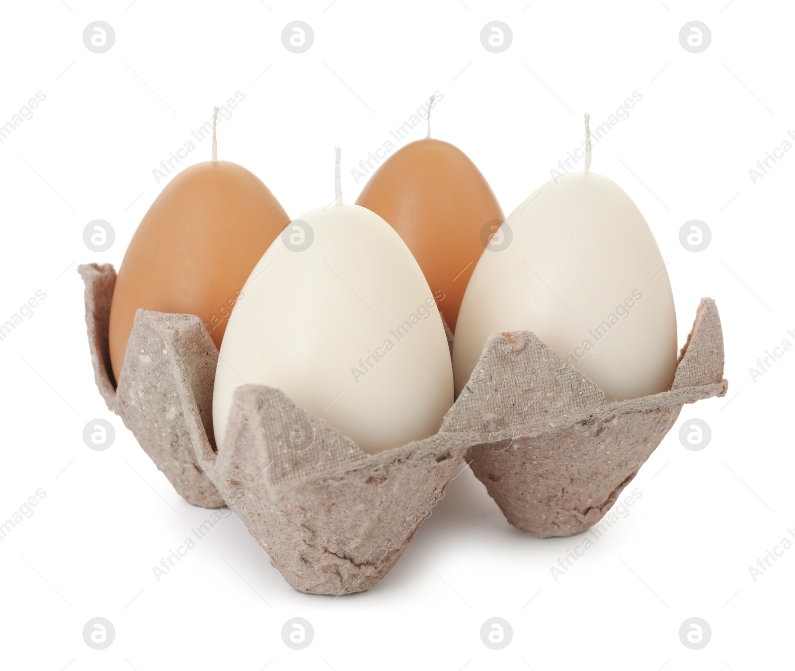 Photo of Egg-shaped candles in carton isolated on white. Easter decor