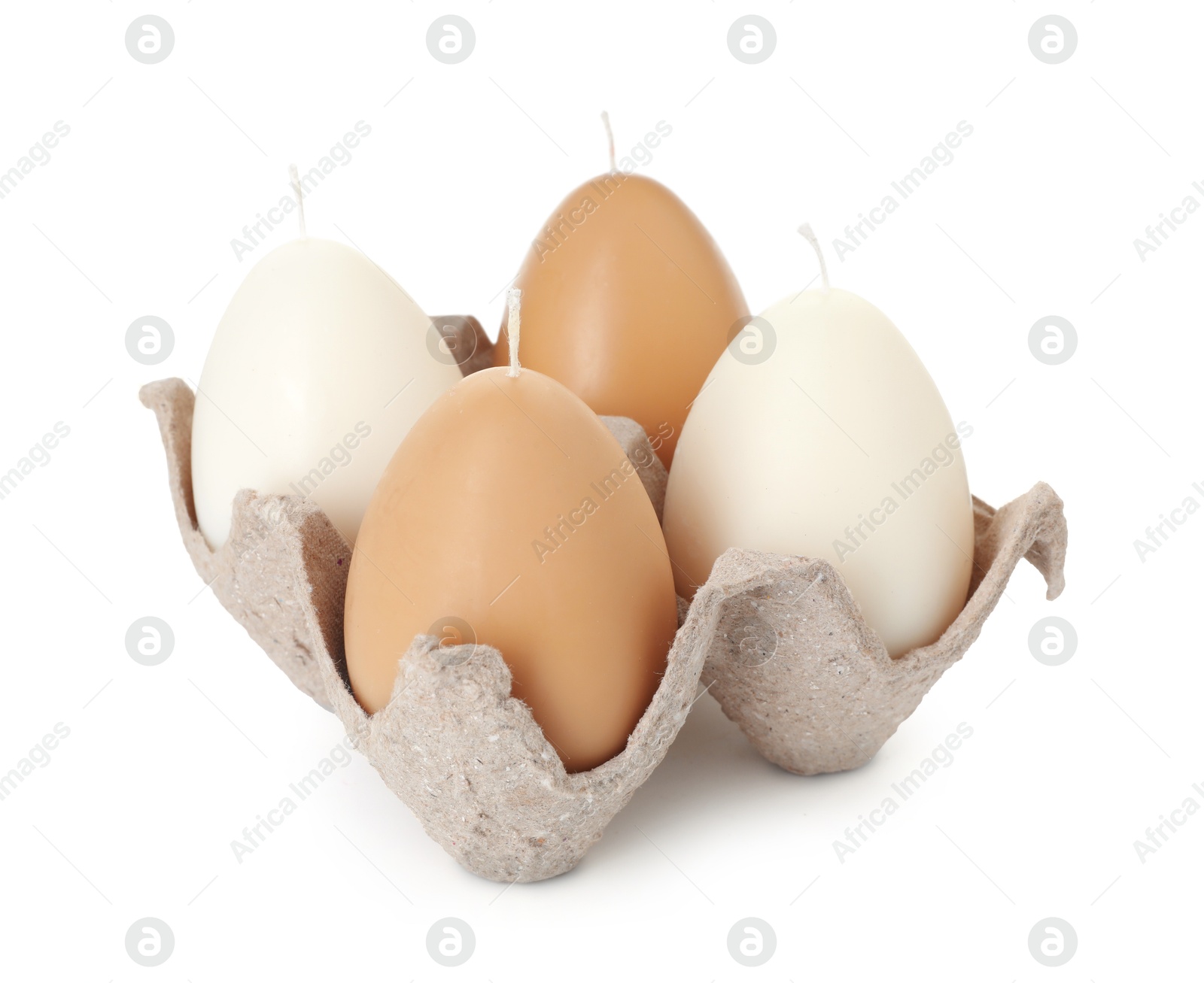 Photo of Egg-shaped candles in carton isolated on white. Easter decor