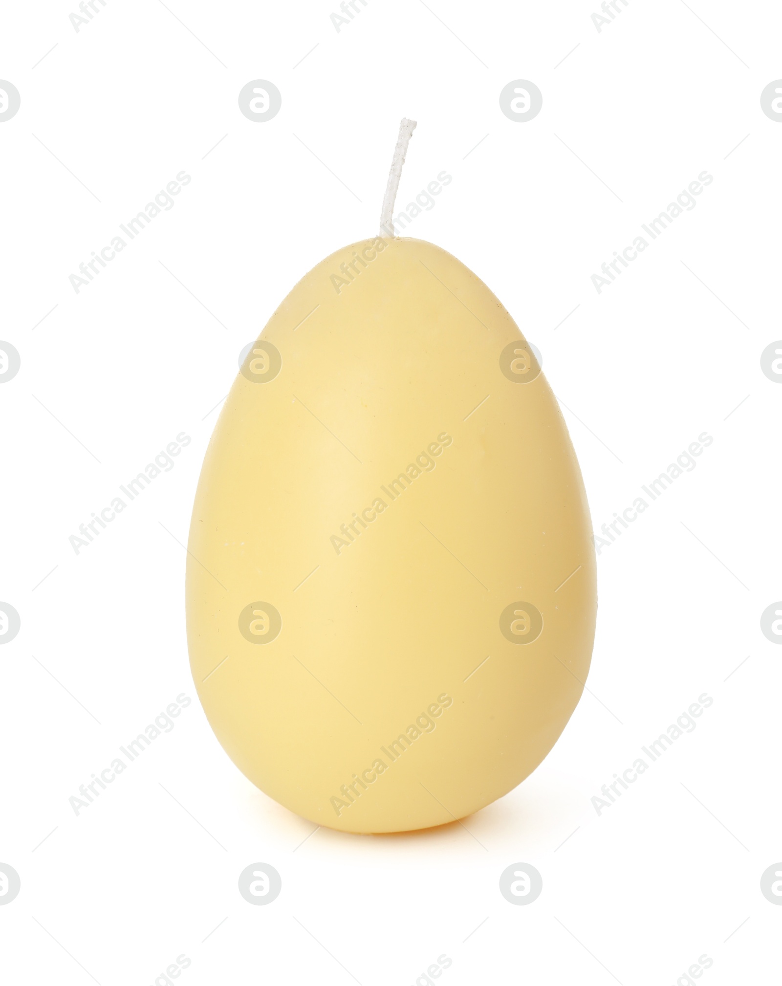 Photo of Yellow egg-shaped candle isolated on white. Easter decor