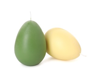 Photo of Colorful egg-shaped candles isolated on white. Easter decor