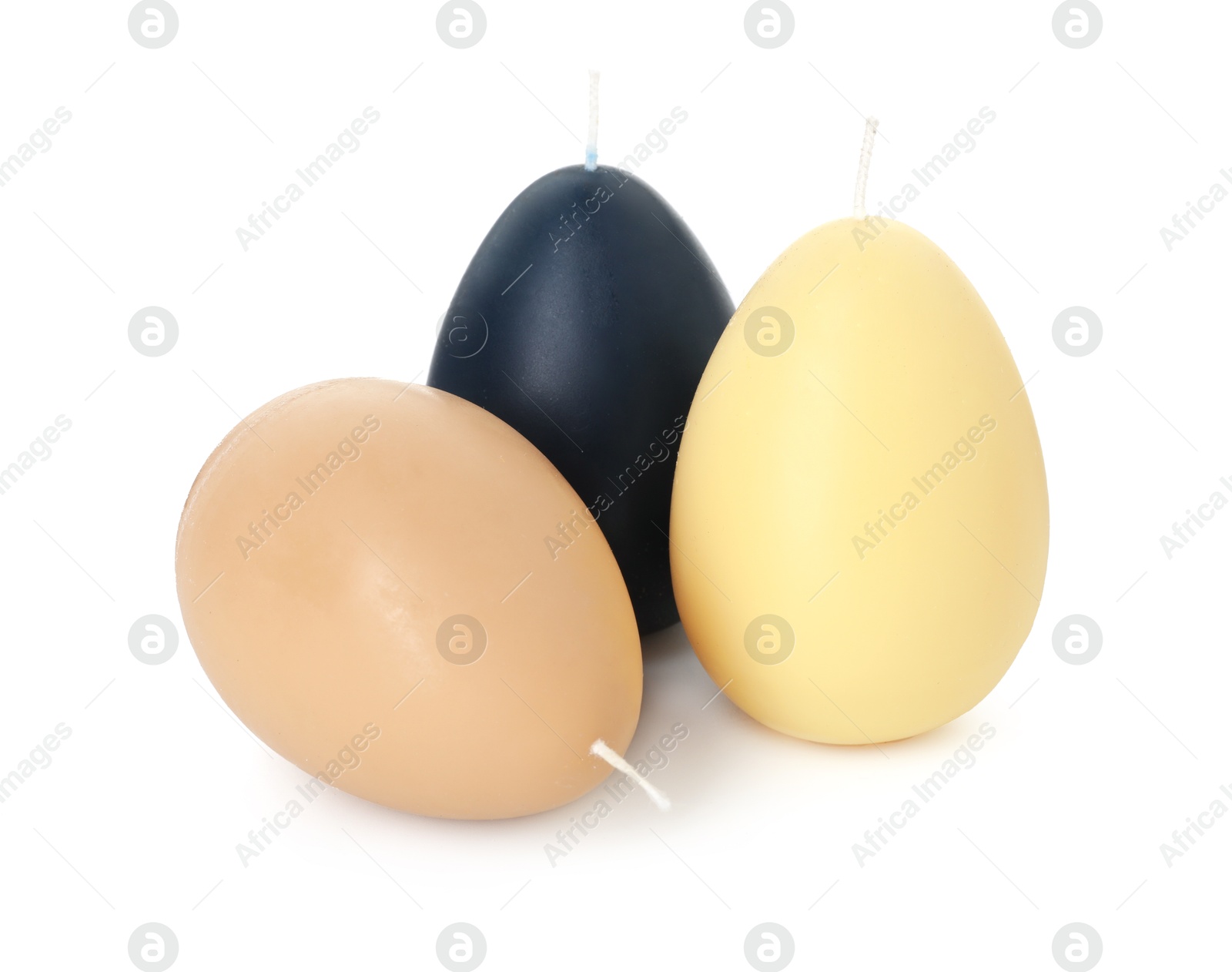 Photo of Colorful egg-shaped candles isolated on white. Easter decor