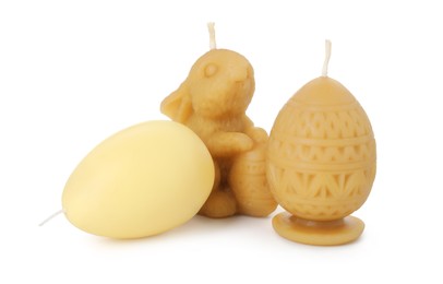 Photo of Bunny and egg shaped candles isolated on white. Easter decor