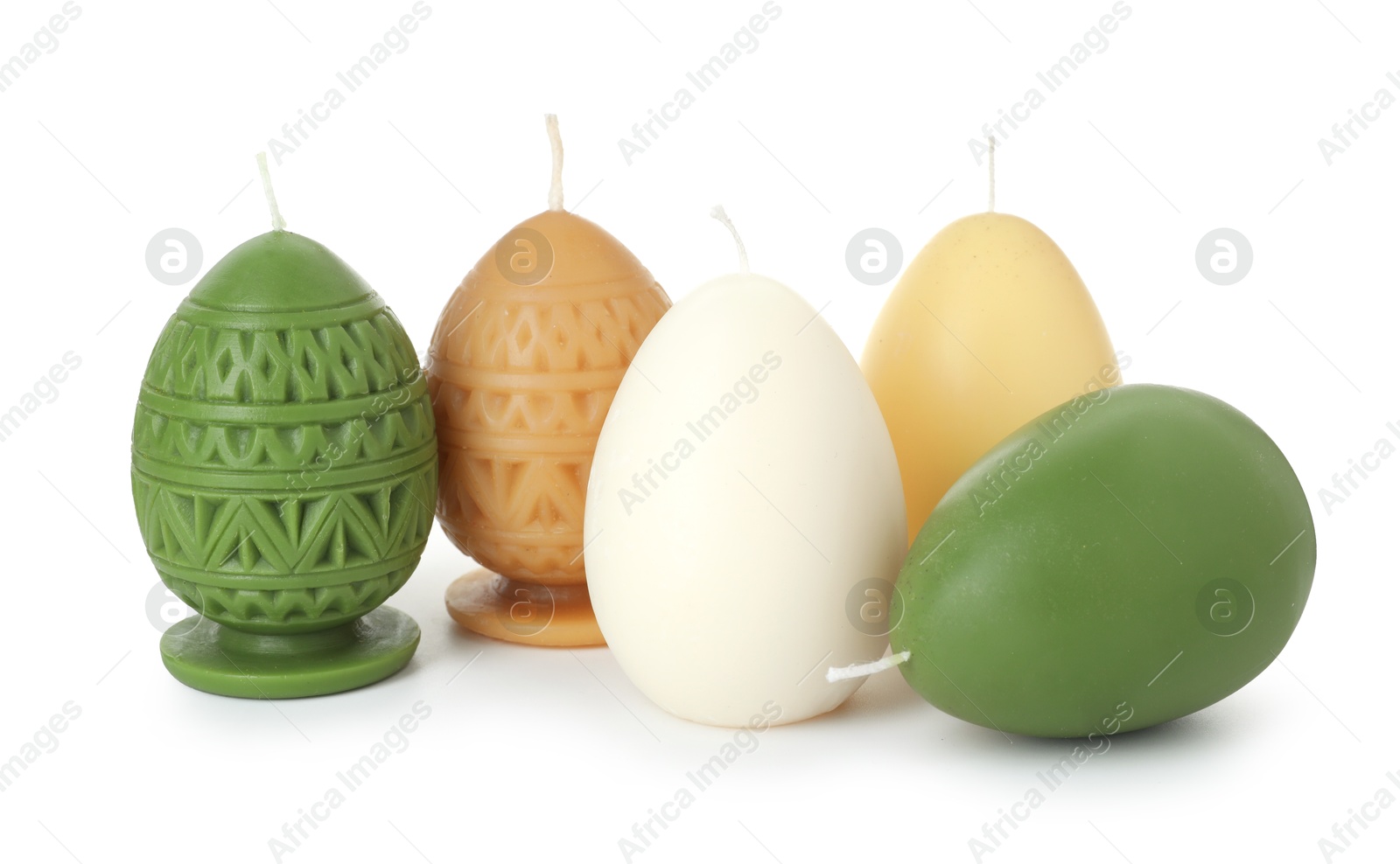 Photo of Colorful egg-shaped candles isolated on white. Easter decor