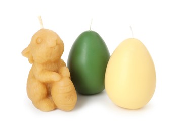 Photo of Bunny and egg shaped candles isolated on white. Easter decor