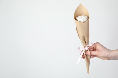 Photo of Woman with beautiful flower shaped candle on white background, closeup. Space for text