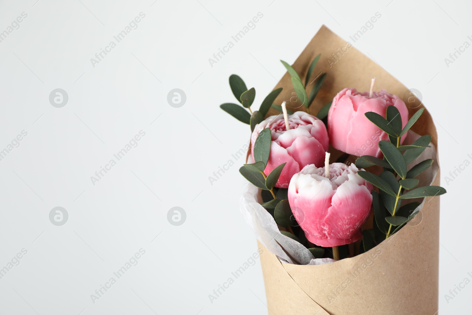 Photo of Bouquet of beautiful flower shaped candles on white background, closeup. Space for text