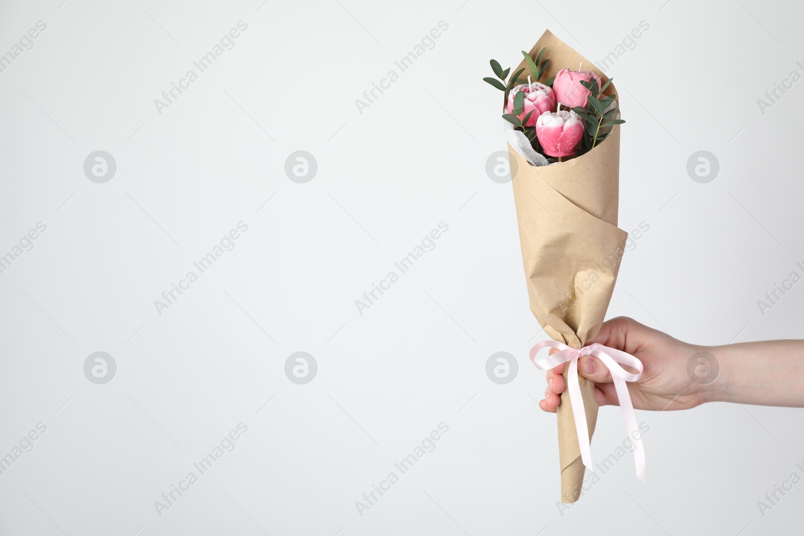 Photo of Woman with bouquet of beautiful flower shaped candles on white background, closeup. Space for text