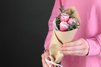 Photo of Woman with bouquet of beautiful flower shaped candles on black background, closeup. Space for text