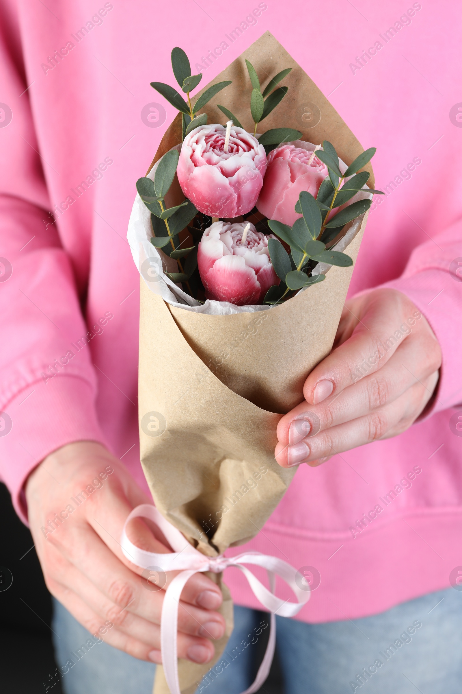 Photo of Woman with bouquet of beautiful flower shaped candles on black background, closeup