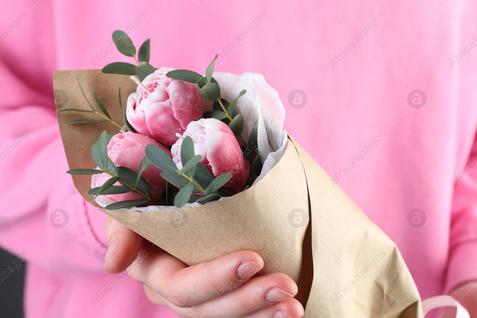 Photo of Woman with bouquet of beautiful flower shaped candles on black background, closeup