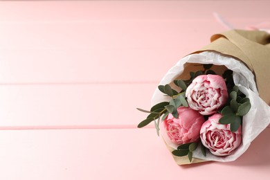 Photo of Beautiful bouquet of flower shaped candles on pink wooden background, closeup. Space for text