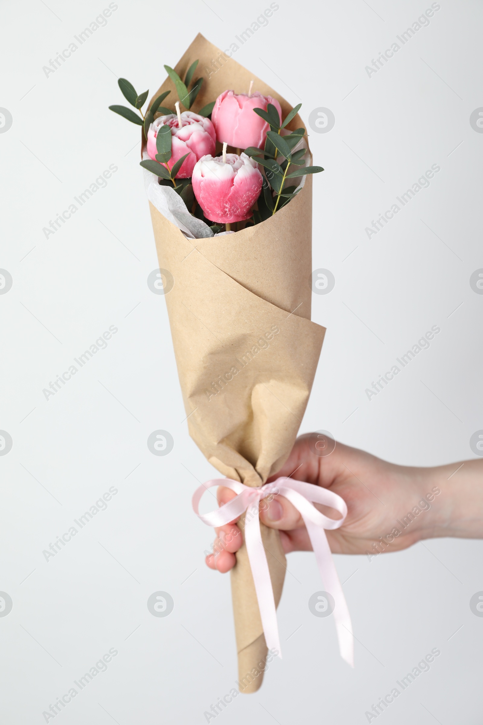 Photo of Woman with bouquet of beautiful flower shaped candles on white background, closeup