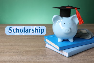 Image of Scholarship. Piggy bank with graduate hat, dollar banknotes and books on wooden table