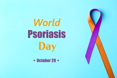 Image of World Psoriasis Day (October, 29). Orange-orchid awareness ribbon on light blue background, top view