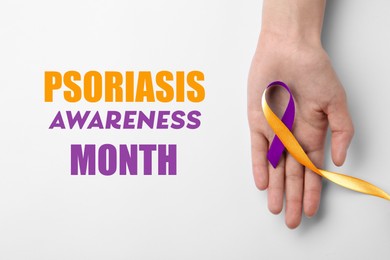 Image of Psoriasis Awareness Month. Woman holding orange-orchid awareness ribbon on white background, top view