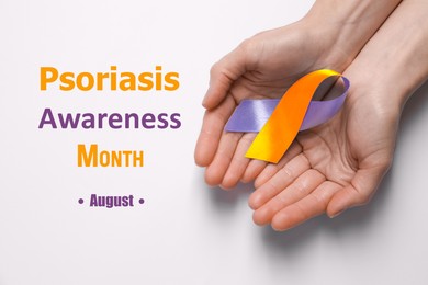 Image of Psoriasis Awareness Month (August). Woman holding orange-orchid awareness ribbon on white background, top view