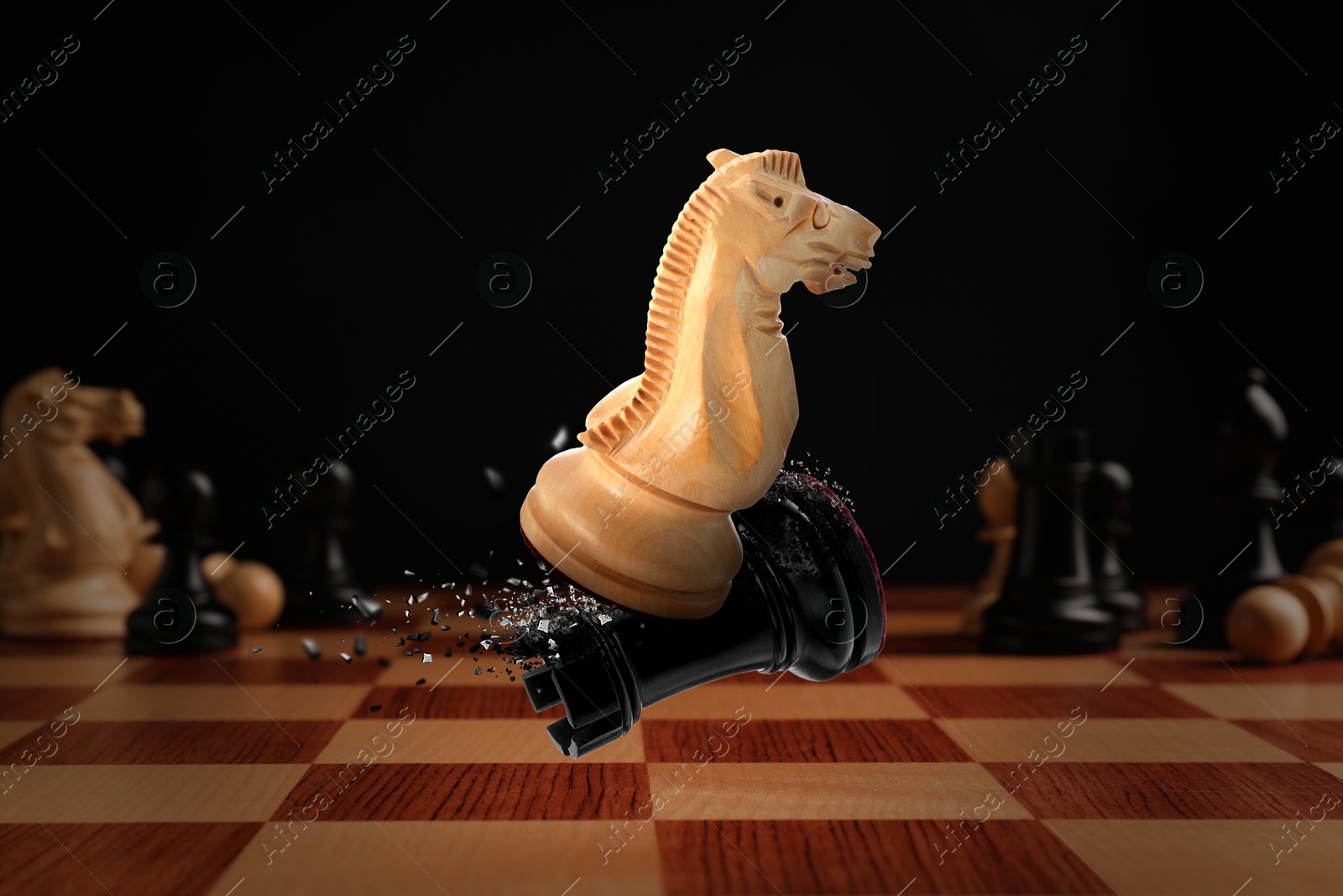 Image of Chess game. White knight beating black rook in air over chessboard