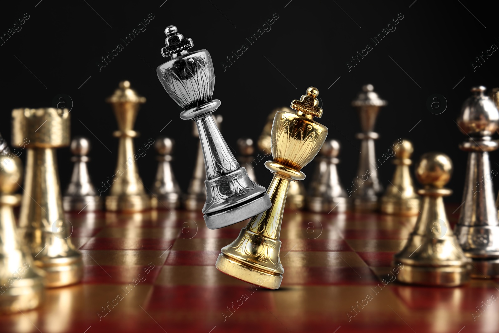 Image of Chess game. Silver king beating golden king on chessboard