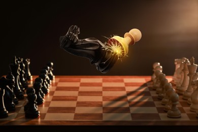 Image of Chess game. Black knight beating white pawn in air over chessboard