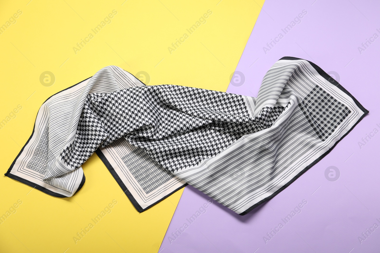 Photo of Beautiful checkered scarf on color background, top view