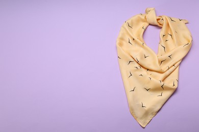 Photo of Beautiful scarf on lilac background, top view. Space for text