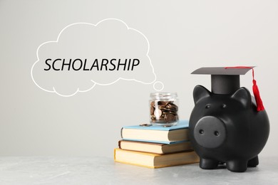 Image of Scholarship. Piggy bank, graduate hat, books and coins on light grey table. Speech cloud with word coming out jar