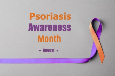 Image of Psoriasis Awareness Month (August). Orange-orchid awareness ribbon on grey background, top view