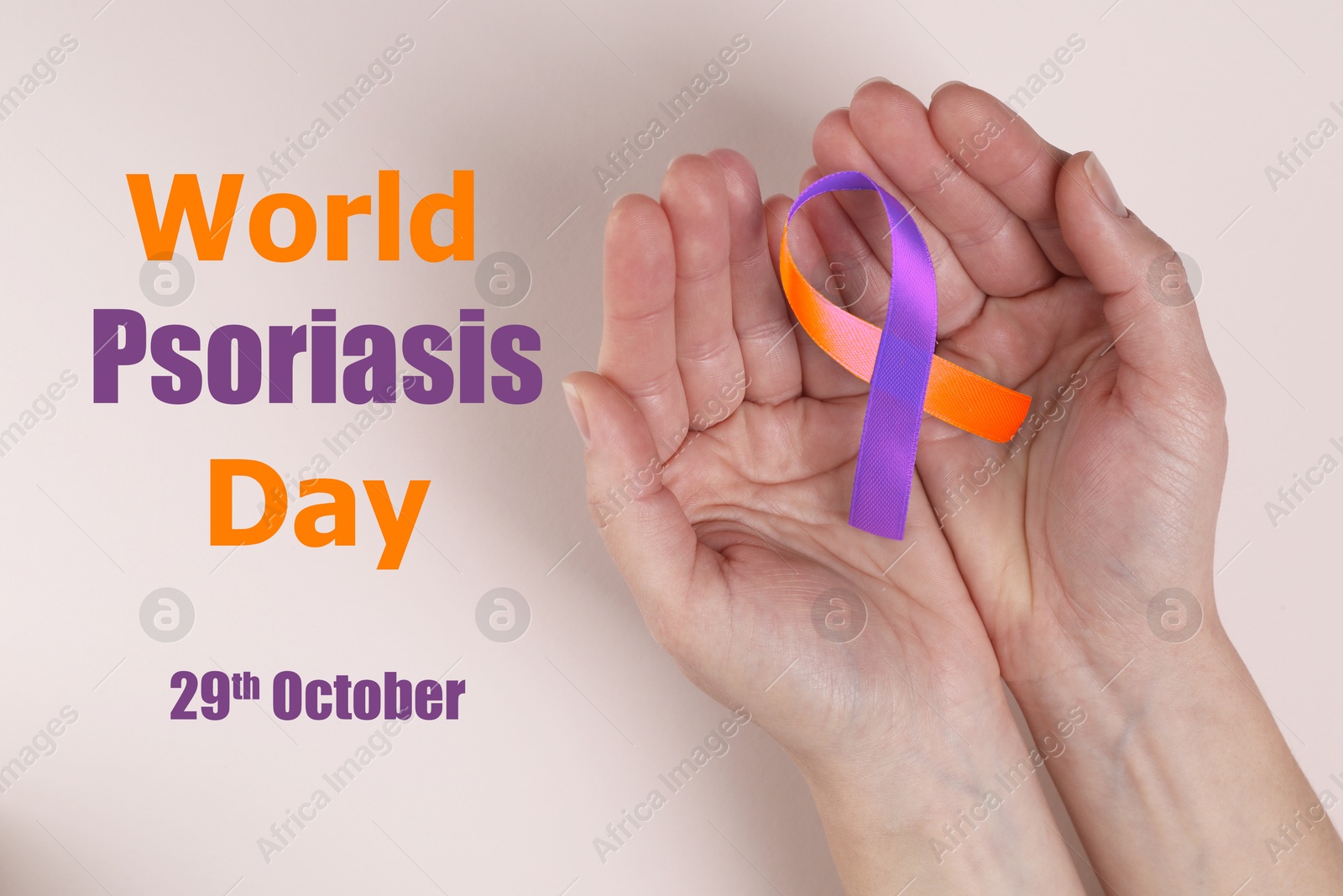 Image of World Psoriasis Day (October, 29). Woman holding orange-orchid awareness ribbon on light background, top view