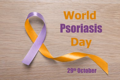 Image of World Psoriasis Day (October, 29). Orange-orchid awareness ribbon on wooden background, top view