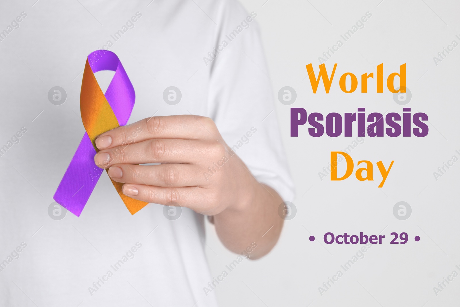 Image of World Psoriasis Day (October, 29). Woman holding orange-orchid awareness ribbon on white background, closeup