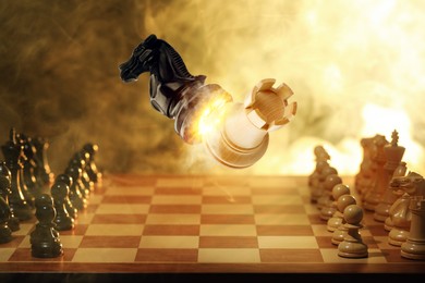 Image of Chess game. Black knight beating white rook in air over chessboard