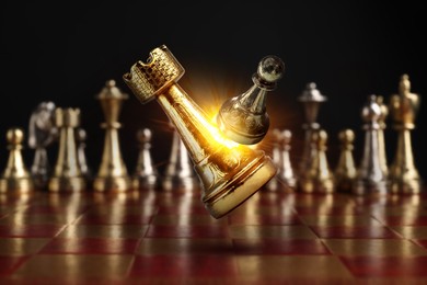 Image of Chess game. Golden rook beating silver pawn in air over chessboard