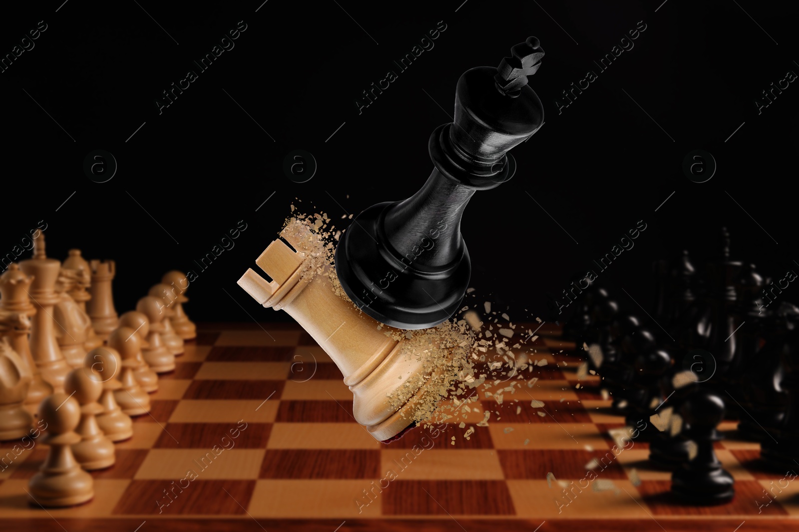 Image of Chess game. Black king beating white rook in air over chessboard