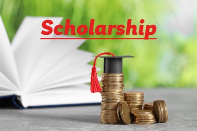 Image of Scholarship. Coins and graduate hat on grey table