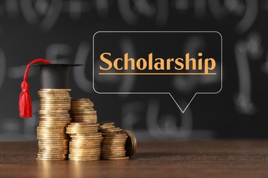 Image of Scholarship. Graduate hat and stacked coins on wooden table against chalkboard. Speech bubble with word