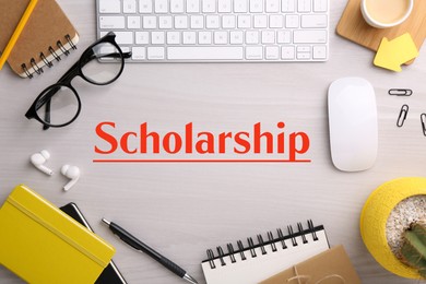 Image of Scholarship. Flat lay composition with different office stationery on white wooden table