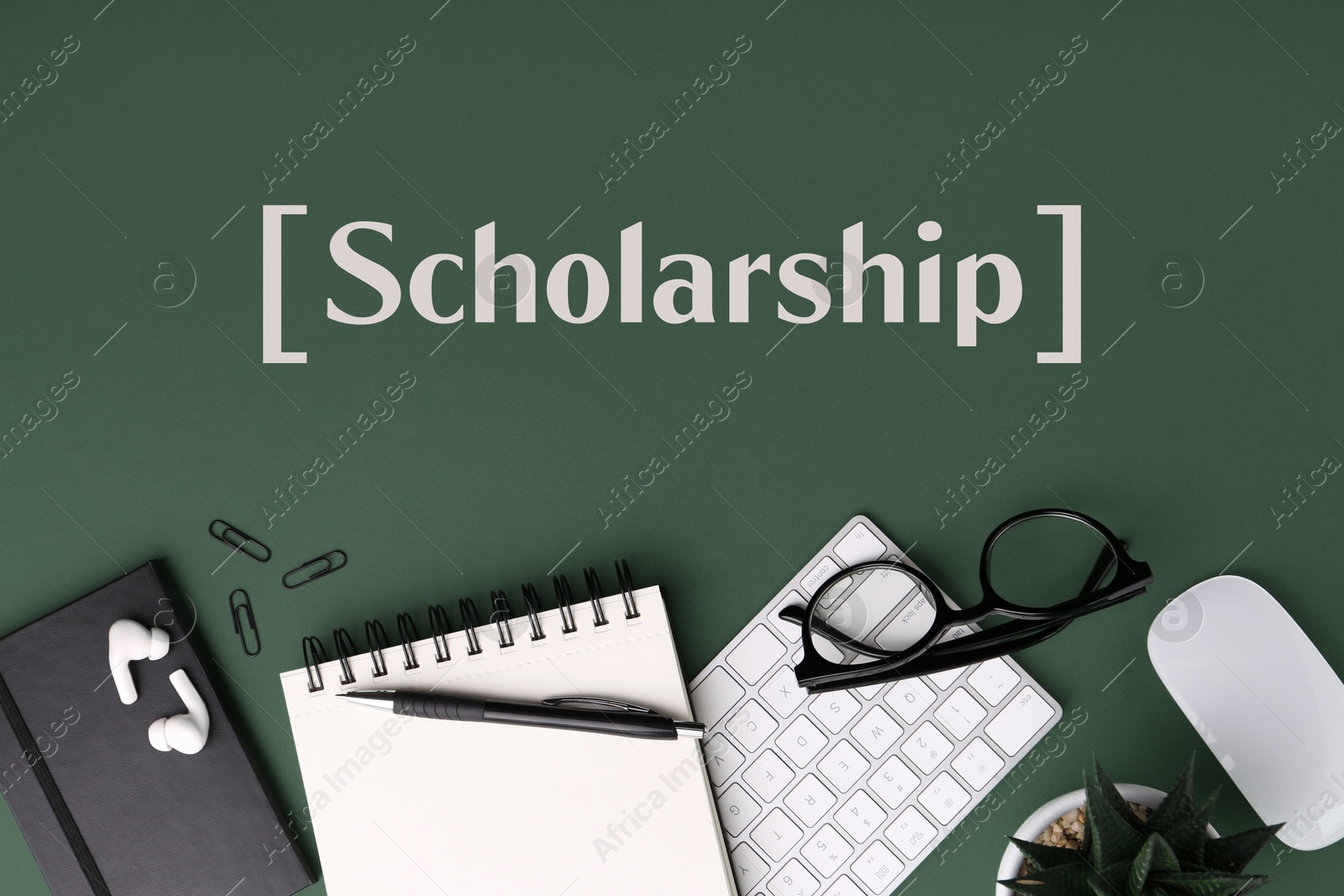 Image of Scholarship. Flat lay composition with different office stationery on green table