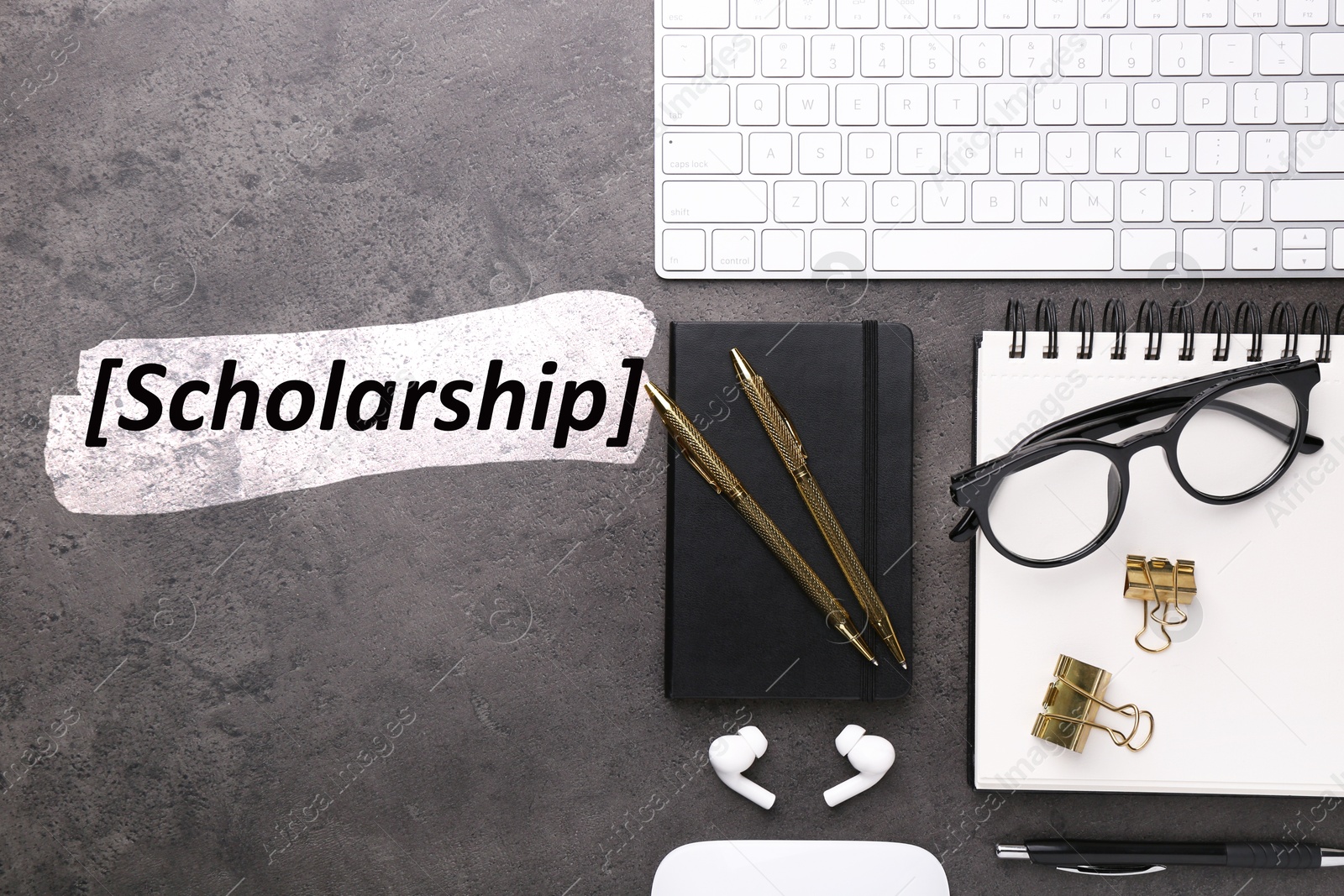 Image of Scholarship. Flat lay composition with different office stationery on dark grey table