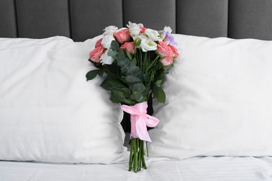 Photo of Wedding bouquet of beautiful flowers and pillows on bed