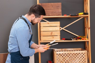 Photo of Relaxing hobby. Man with chisels in workshop