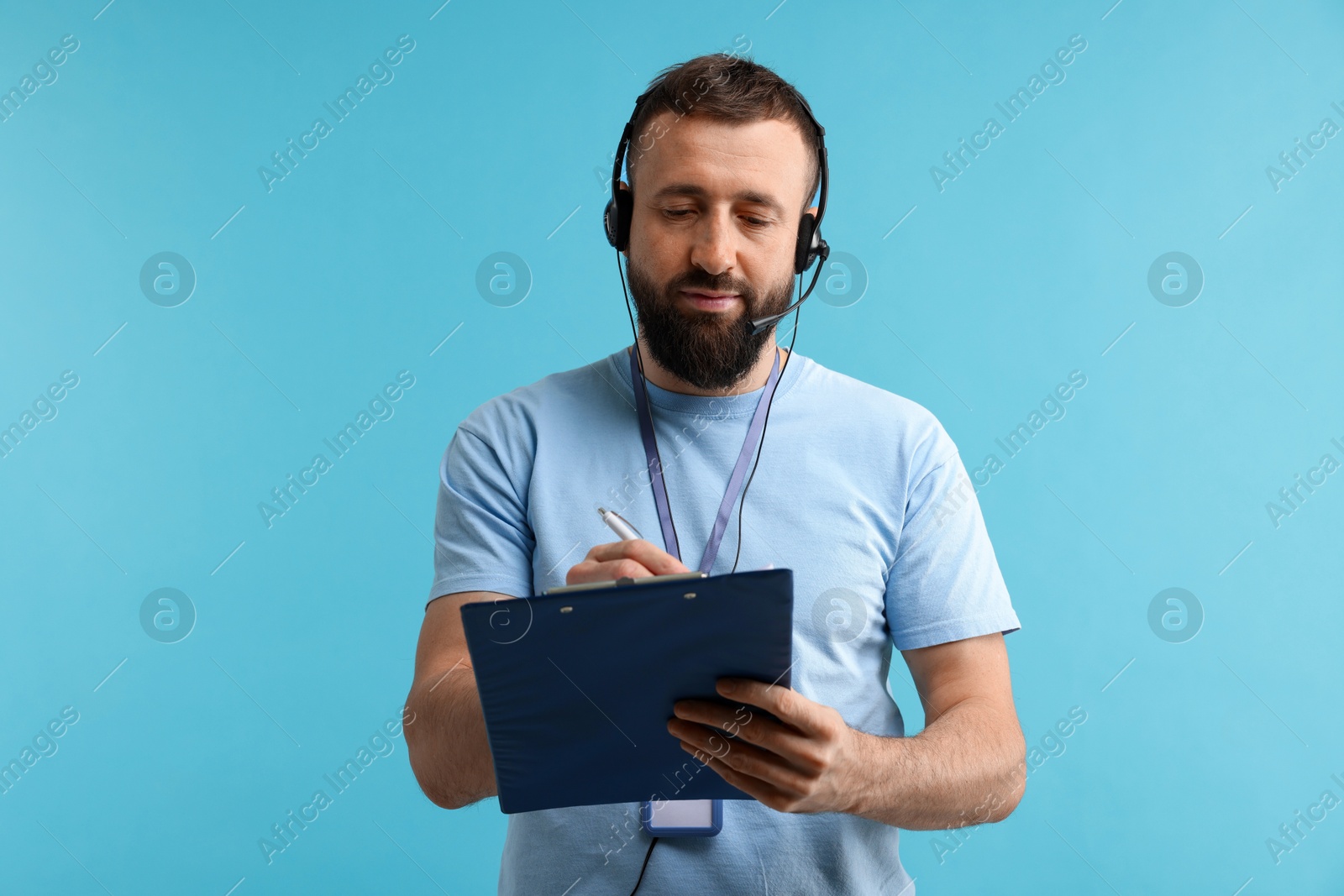 Photo of Technical support call center. Operator with clipboard on light blue background