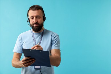 Photo of Technical support call center. Operator with clipboard on light blue background. Space for text