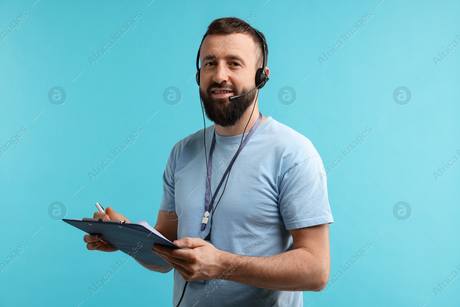 Photo of Technical support call center. Smiling operator with clipboard on light blue background