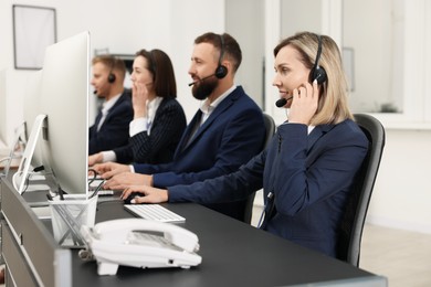 Photo of Technical support call center. Team of operators working in office