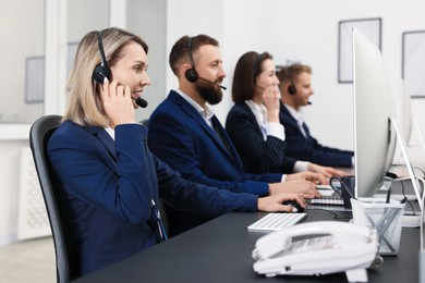 Photo of Technical support call center. Team of operators working in office