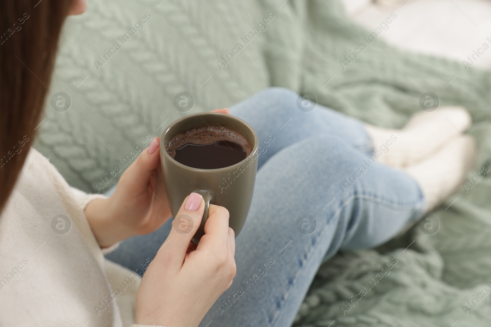 Photo of Woman holding mug of tasty hot chocolate, closeup