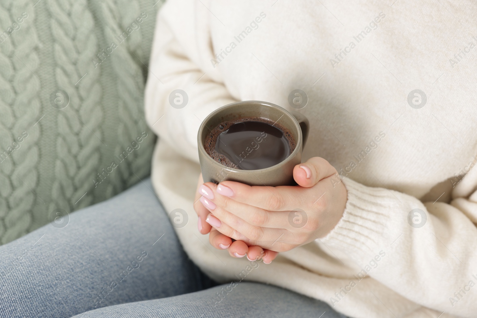 Photo of Woman holding mug of tasty hot chocolate, closeup